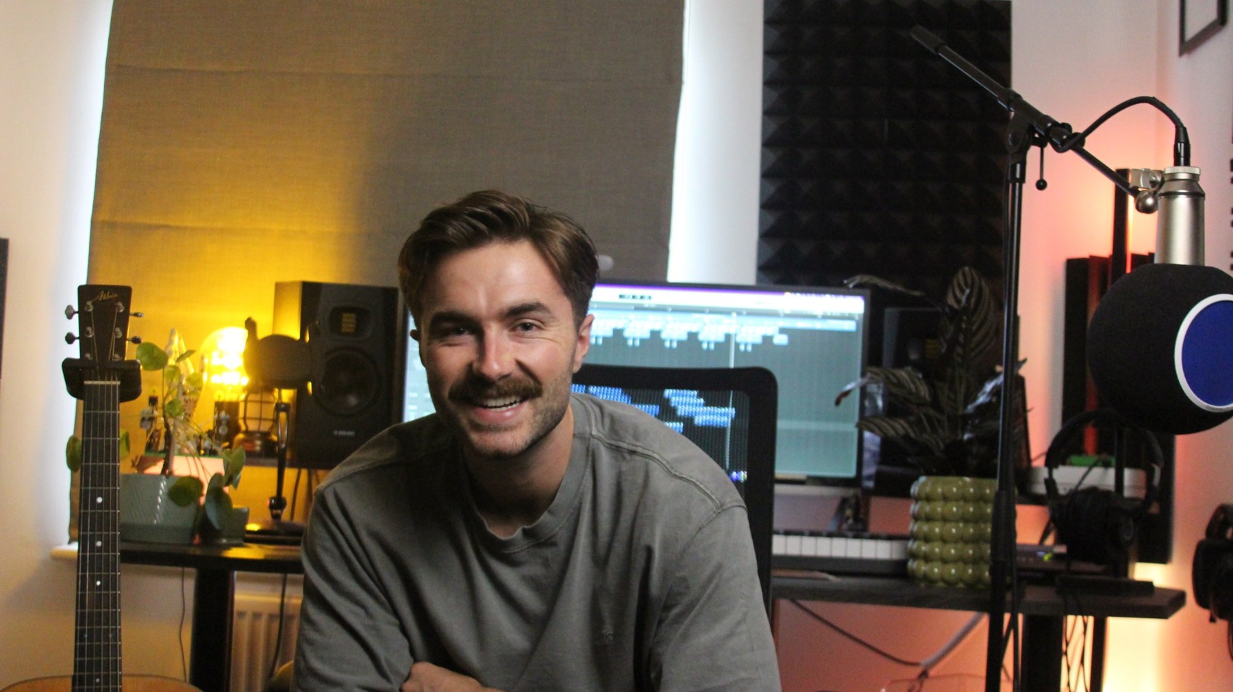 Charlie smiling in his music studio